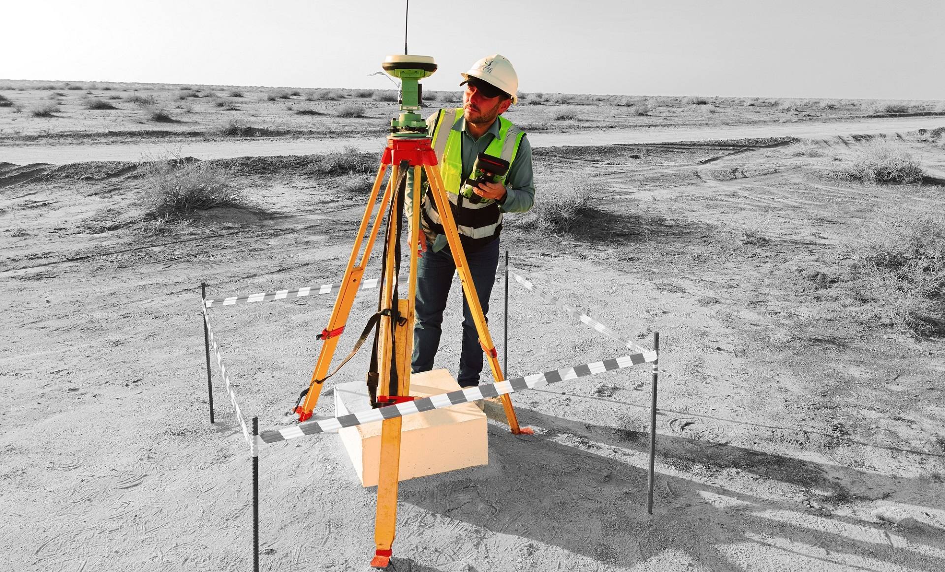Land surveyor using a GNSS receiver on site in Saudi Arabia